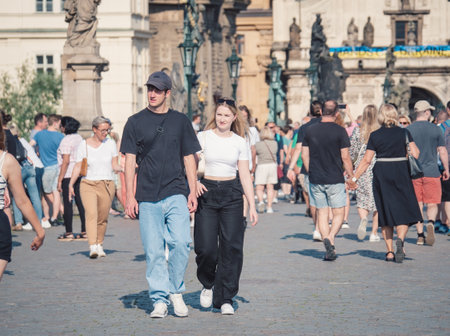 Prague, Czech Republic - June 2022: Happy smilling tourists strolling and taking pictures on the famous Charles Bridge in Prague.のeditorial素材