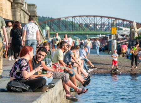 Prague, Czech Republic - June 2022: Tourists and locals sitting and having a beer on Naplavka along the Vltava river, in Pragueのeditorial素材
