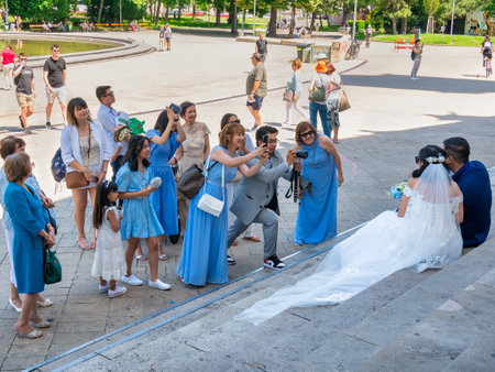 Vienna, Austria - June 2022: Asian tourists taking pictures on the steps of Karlskirche (St. Charles Church) Habsburg baroque cathedral located on the south side of Karlsplatz in Viennaのeditorial素材