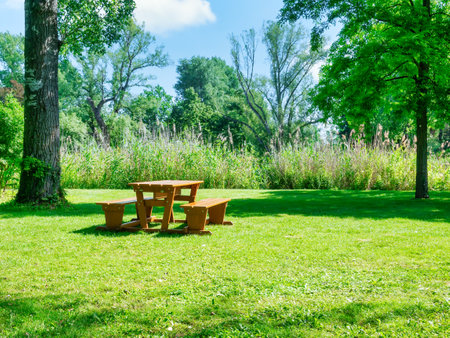 Wooden table with chairs for picnic and resting in Donau Park Vienna, Austria.の写真素材