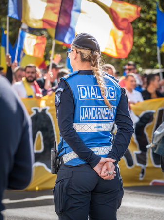 Bucharest, Romania - October 2022: : Female police officers and Gendarmerie or military police closely supervising the demonstrators at a protest in Bucharest.のeditorial素材