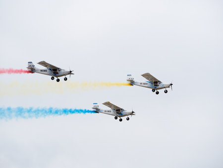 Bucharest, Romania - September 2022: Three ICP Savannah ultra light high wing sport aircraft leaving trails with the colors of the national flag of Romania. Bucharest International Aviation Show.のeditorial素材