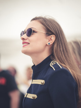 Bucharest, Romania -September 2022: Portrait of a attractive young girl wearing sun glasses.Beautiful girl smiling. Street photography.のeditorial素材