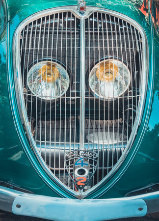 Bucharest, Romania - 07.15.2022: Front view close up detail with the vintage Peugeot 402 Eclipse.