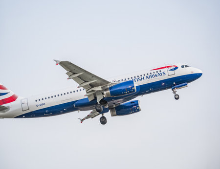 Bucharest, Romania - August 2022: A British Airways Airbus A320-232 airplane flying against blue sky from Henri Coanda International Airport.のeditorial素材