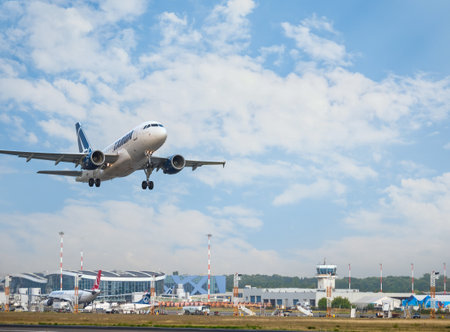Bucharest, Romania - August 2022: TAROM Airbus A318 airplane flying against the sky at sunset. Airplane takes off from Henri Coanda International Airport.のeditorial素材