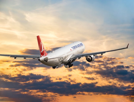Bucharest, Romania - August 2022: A Turkish Airlines Airbus A330-300 airplane flying against the sky at sunset. Airplane takes off from Henry Coanda International Airport.のeditorial素材