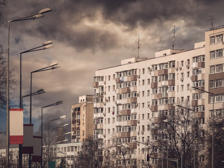 Worn out apartment building from the communist era against blue sky in Bucharest Romania. Ugly traditional communist housing ensembleの写真素材