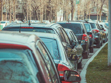 Many cars parked on the sidewalk and street in Bucharest, Romania.の写真素材
