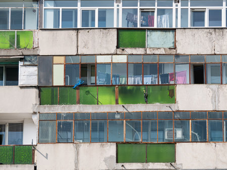 Worn out apartment building from the communist era against blue sky in Bucharest Romania. Ugly traditional communist housing ensembleの写真素材