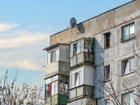 Worn out apartment building from the communist era against blue sky in Bucharest Romania. Ugly traditional communist housing ensembleの写真素材