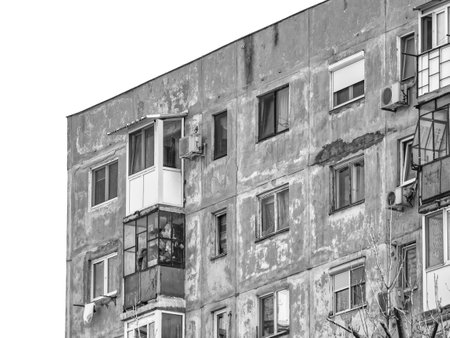 Worn out apartment building from the communist era against blue sky in Bucharest Romania. Ugly traditional communist housing ensemble. Black and white abstract photography.の写真素材