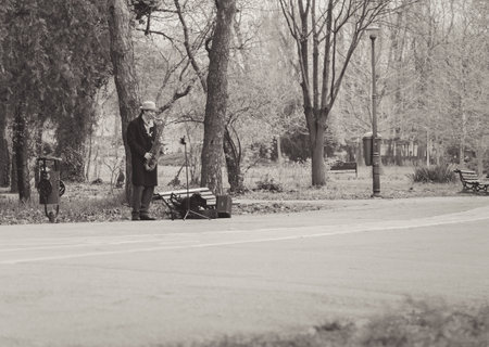 Bucharest, Romania - April 2023: Street musician man playing at saxophone in King Mihai I park ( Herestrau), in Bucharest.のeditorial素材