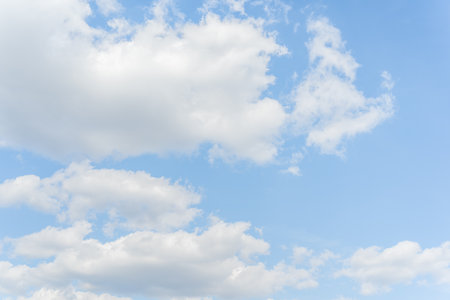 White clouds on a blue sky background.の写真素材