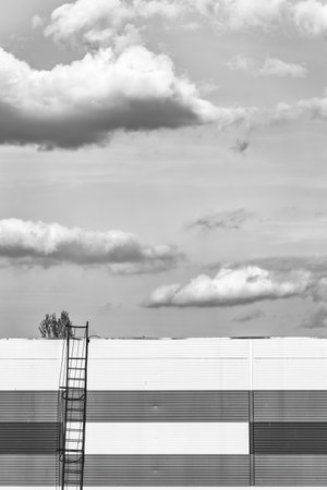 Abstract monochrome minimalist picture with a staicase leading to a dramatic sky.の写真素材