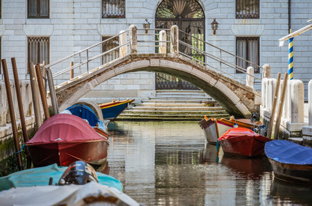 Picturesque Scene from Venice with many boats parked on the narrow water canals.の写真素材