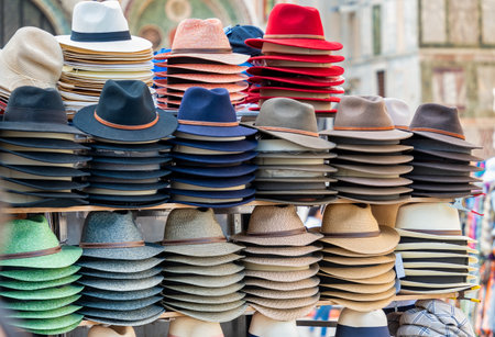 Different types of hats on display for sale at the market.の写真素材