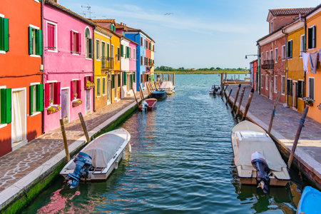 Colorful houses along the water canal in the island of Burano, Venice.の写真素材