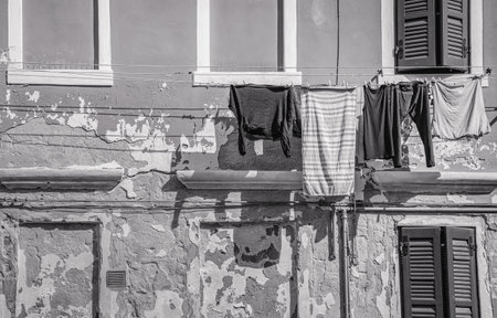 Clothes hanging on wire to dry outside, in Venice. Black and white photographyの写真素材