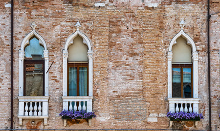 Close up detail with old medieval architecture venetian window and balcony.の写真素材