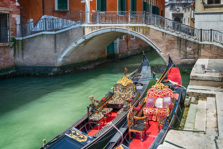 Colorful picture with gondolas moored on the water canals, in Venice Italy.の写真素材