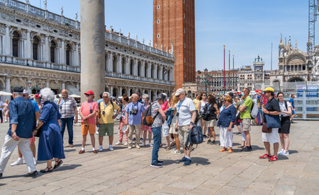 Venice, Italy - May 29 2023: Organized group of senior tourists visiting Piazzetta San Marco and Colonna di San Marco in Venice.のeditorial素材