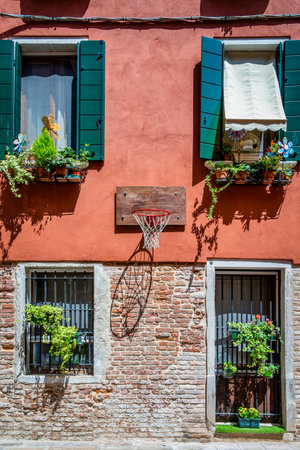 Close up detail with old medieval architecture venetian window. Open wooden shuttersの写真素材