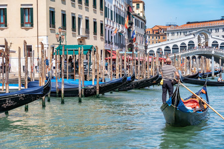 Venice, Italy - May 30 2023: Traditional gondola ride on the Grand Canal near Rialto Bridge (Ponte di Rialto). Tourists in Venice.のeditorial素材