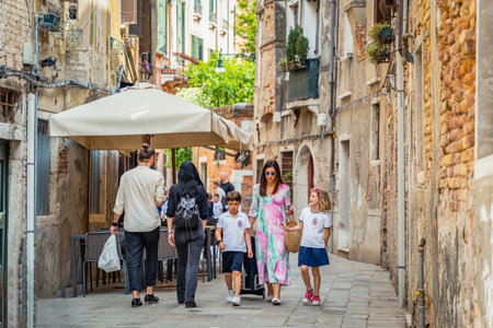 Venice, Italy - May 30 2023: Local scene from the cooblestone streets of Venice. Everyday life in Venice.のeditorial素材