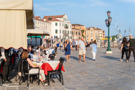 Venice, Italy - May 29 2023: Crowds of tourists strolling on the cobblestone alley near Grand Canal in Venice.のeditorial素材