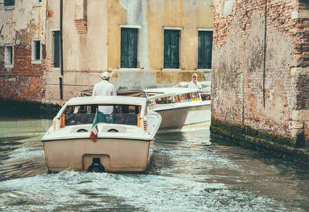 Venice, Italy - May 31 2023: Traffic jam on the narrow water canals in Venice.Taxi motor boats.のeditorial素材