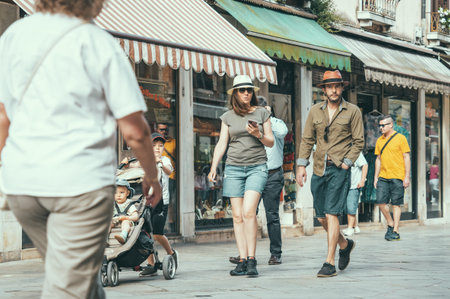 Venice, Italy - May 31 2023: Elegant tourist couple on the streets of Venice.のeditorial素材