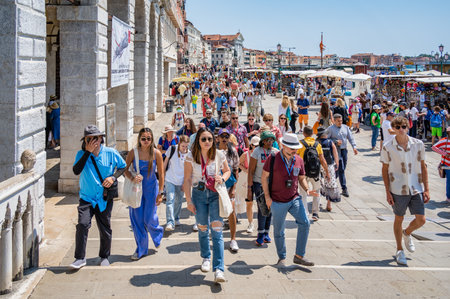 Venice, Italy - May 31 2023: Crowds of tourists strolling on the cobblestone alley near Grand Canal in Venice.のeditorial素材