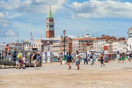 Venice, Italy - May 31 2023: Crowds of tourists strolling on the cobblestone alley near Grand Canal in Venice.のeditorial素材