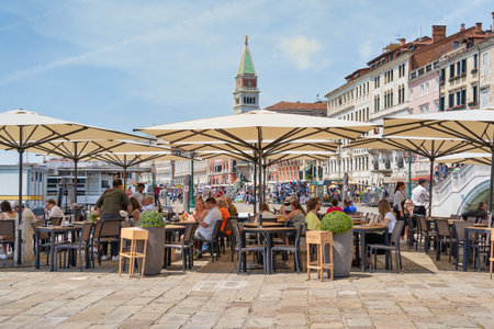 Venice, Italy - May 31 2023: Outdoor restaurant cafe in Venice.のeditorial素材