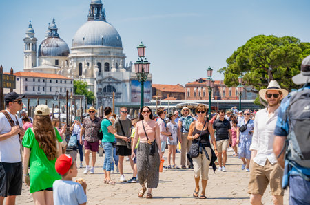 Venice, Italy - May 31 2023: Crowds of tourists strolling on the cobblestone alley near Grand Canal in Venice.のeditorial素材