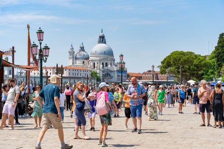Venice, Italy - May 31 2023: Crowds of tourists strolling on the cobblestone alley near Grand Canal in Venice.のeditorial素材