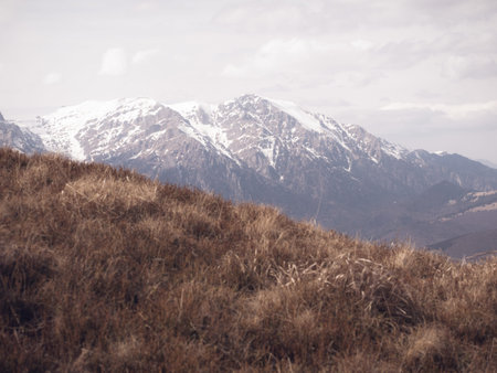 Scenic view from Baiului Mountains with the snowy peaks of Bucegi Mountains. Carpathians in Romania.