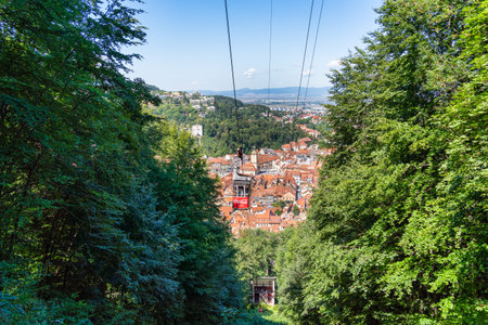 Brasov, Romania - September 02 2023: Cable car going to Mount Tampa summit with the city of Brasov in the background.のeditorial素材