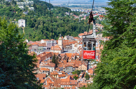 Brasov, Romania - September 02 2023: Cable car going to Mount Tampa summit with the city of Brasov...