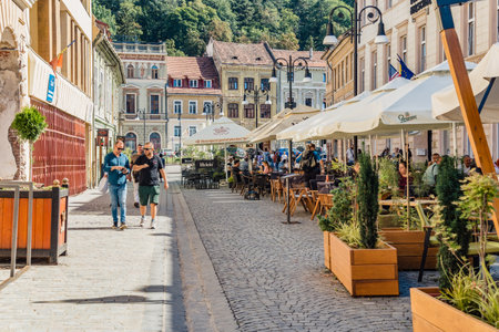 Brasov, Romania - September 02.2023: Tourists and locals strolling on the pedestrian area in the old town center of Brasov.のeditorial素材