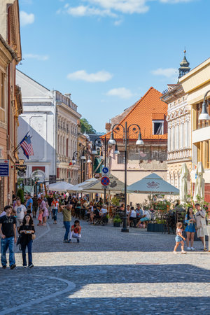 Brasov, Romania - September 02.2023: Tourists and locals strolling on the pedestrian area in the old town center of Brasov.のeditorial素材
