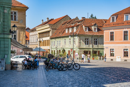 Brasov, Romania - September 02.2023: Tourists and locals strolling on the pedestrian area in the old town center of Brasov.のeditorial素材