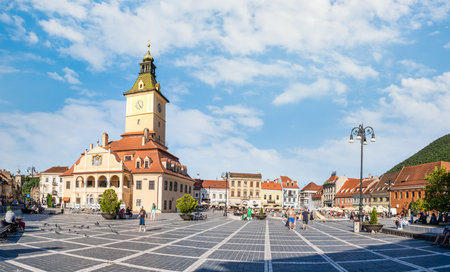 Brasov, Romania - September 02.2023: Tourists and locals strolling on the pedestrian area in the old town center of Brasov. City hall building in Council Square.のeditorial素材