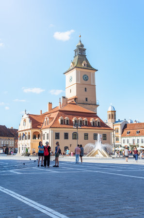 Brasov, Romania - September 02 2023: Brasov city hall clock tower located in the old town Council Square.のeditorial素材
