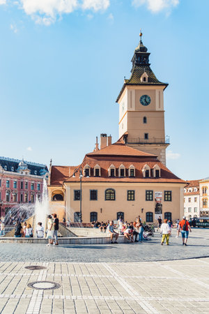 Brasov, Romania - September 02 2023: Brasov city hall clock tower located in the old town Council Square.のeditorial素材