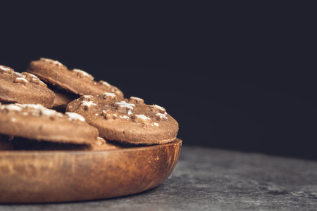 Delicious sweet cocoa cookies biscuits on a wooden plateの写真素材