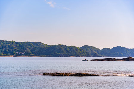 A fisherman in a fishing boat in Nachi bay, Japan. Scenic cview from the Pacifi coast in Nachikatsuura, Higashimuro District, Wakayamaの写真素材