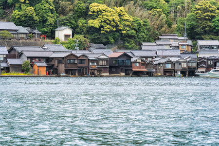 Beautiful scenic view with the wooden traditional waterfront boat houses called funaya around Ine...