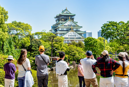 Osaka, Japan - 05.05.2024: Crowd of tourists visiting Osaka Castle, the most famous landmark and popular tourist attractions in Osaka, Japan.の写真素材
